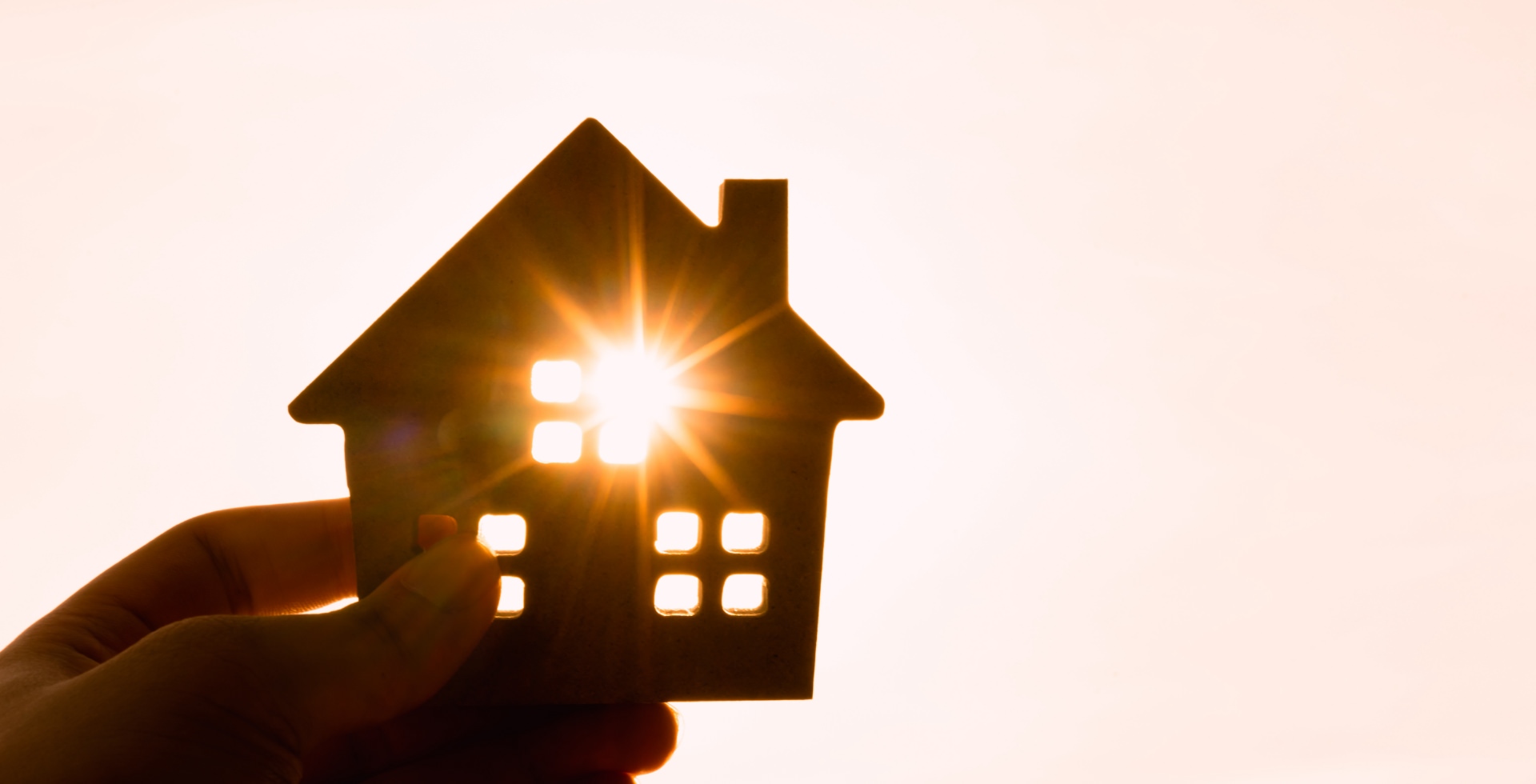 Cardboard house with sun shining through it